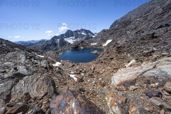 Blue glacial lake in a rocky mountain landscape, Königshofspitz in the background, descent from the