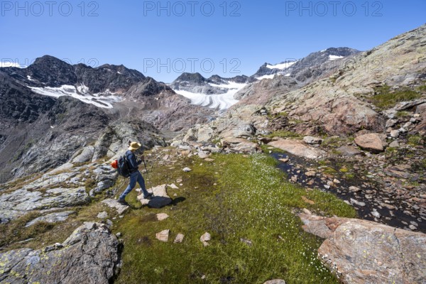 Mountaineer walking over stones, rocky mountain landscape, behind Königshofspitz, Schwarzwandspitz
