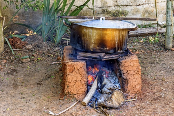 Food being prepared in the backyard on a wood-burning stove typically used in Minas Gerais, Brazil,