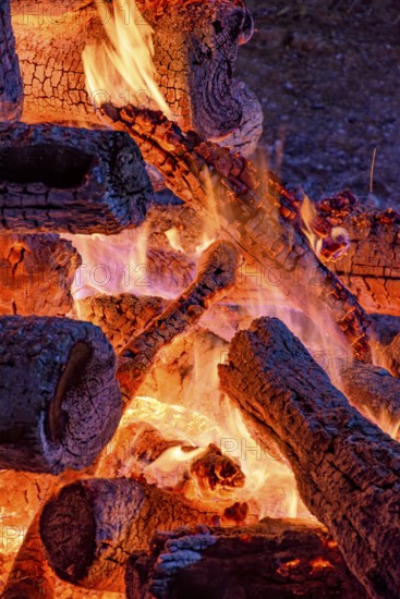 Logs of burning wood burning in a bonfire during a religious festival in honor of Saint John in