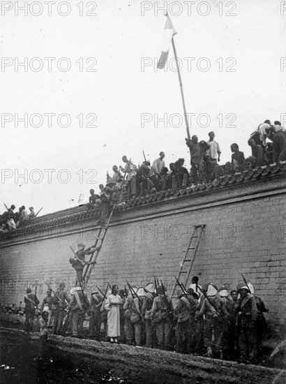 Boxer Rebellion, China, protests on a wall during the Boxer War. Chinese people gather on a wall