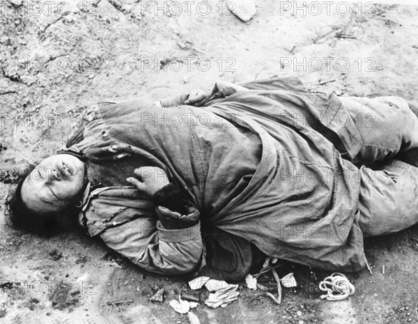 Chinese woman in Brenan Road, Shanghai. Shot for looting. The Second Sino-Japanese War began on 7