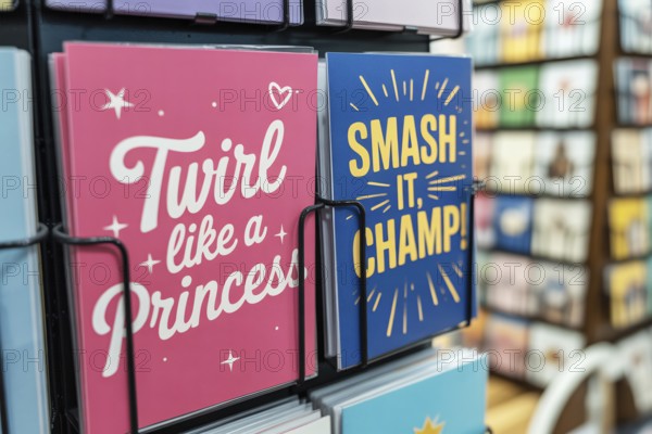 Pink and blue birthday greeting cards on a rack. Gender stereotypes and societal expectations