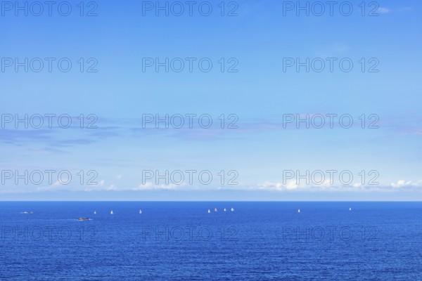 Sea view towards the horizon with sailboats sailing on the blue sea a sunny summer day, Crozon