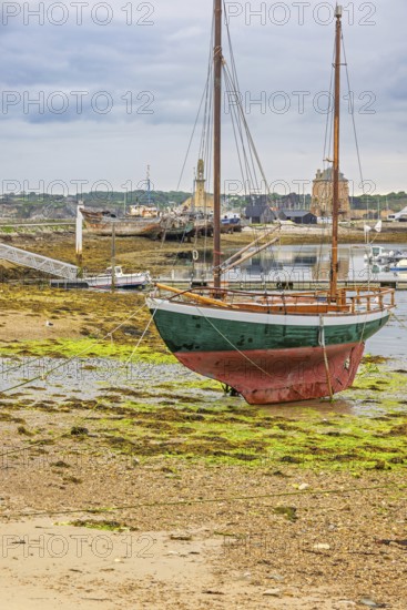 Old wooden sailboat on the shore at low tide on the coast, Camaret-sur-Mer, Crozon Peninsula,