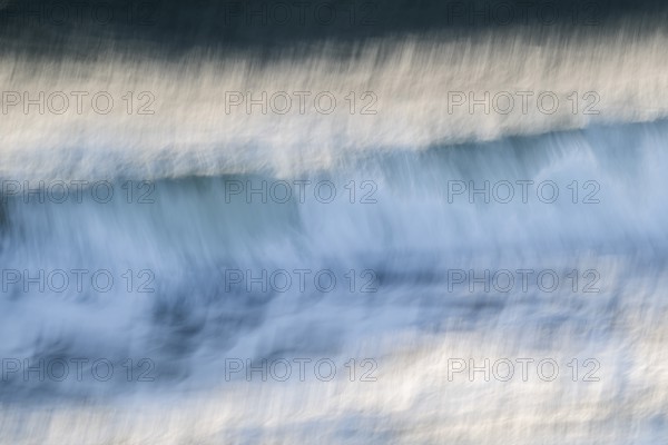 Dynamic waves with a blurred effect create a feeling of movement on the sea, near Hvide Sande,
