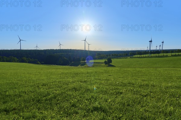 Wind turbines towering on a green meadow under a bright sky, summer, Rohren, Monschau, Eifel, North