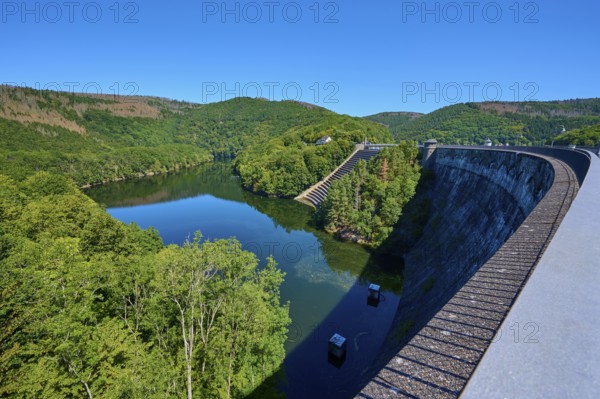 View of a large dam with river and surrounding forest landscape, summer, Urft dam wall, Obersee,
