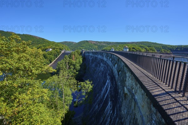 High view of a large dam with neighbouring forest and clear sky, summer, Urft dam wall, Obersee,