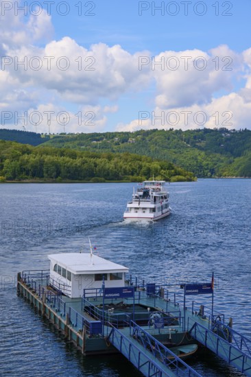 A passenger ship moves away from the landing stage, on a large lake, summer, Rursee, Rurtalsperre,
