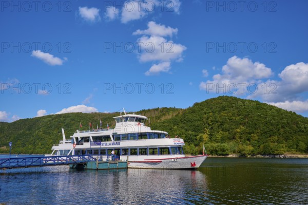 Passenger ship at the jetty, surrounded by green hills and blue sky, summer, Rursee, Rurberg,
