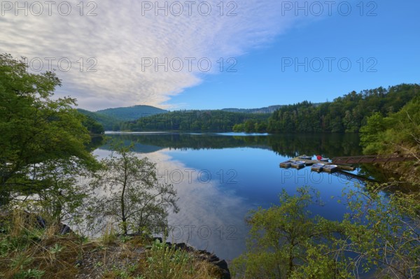 Clear water reflection of a wooded mountain on the lake, summer, Rursee, Obersee, Simmerath, Eifel