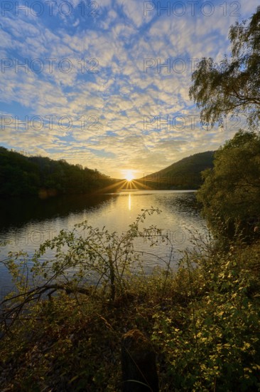 Golden sunbeams spread across the lake, dramatically surrounded by clouds, summer, Rursee, Obersee,