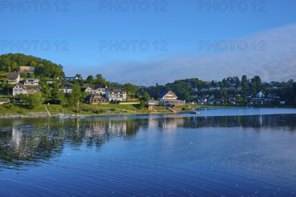 Idyllic lake with houses on the shore, clear blue sky on a sunny summer day, summer, Rursee,