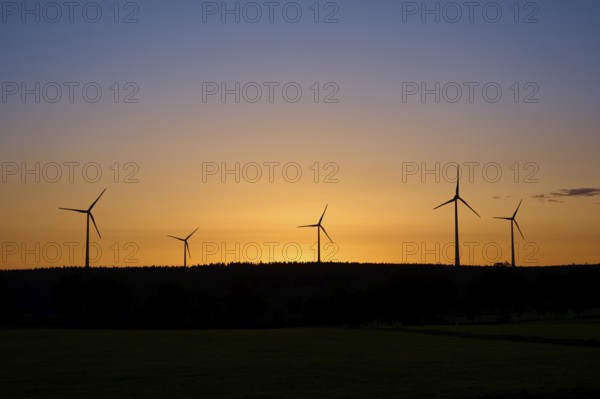 Wind turbines in front of an orange-coloured sunrise, Rohren, Monschau, Eifel, North