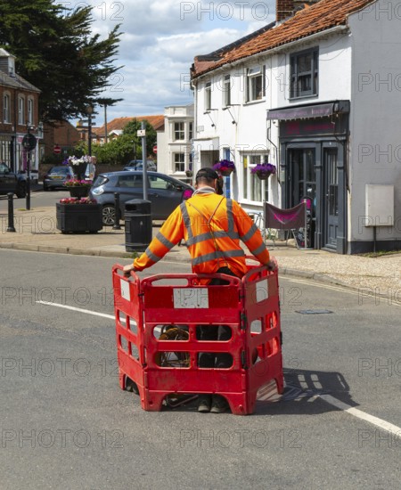 British Telecom technicians working on fibre optic Broadband in street, Southwold, Suffolk,