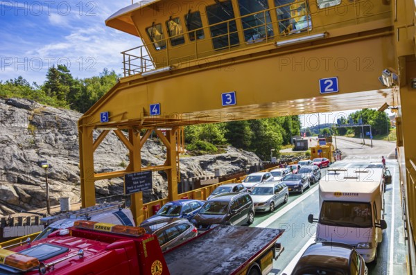Cars and lorries on a car ferry operating as a floating road, near Lysekil, BohuslÃ¤n, VÃ¤stra