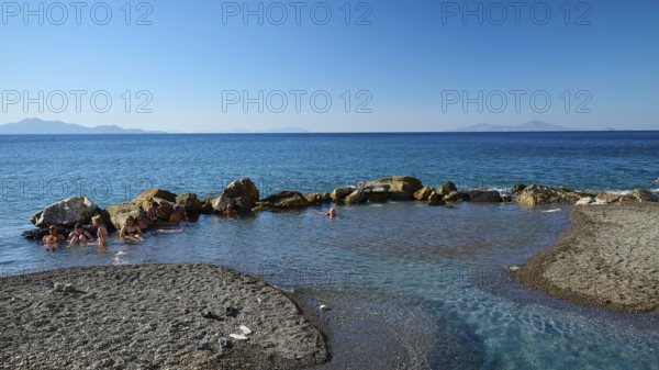 Rocks in clear blue sea, calm coastal landscape in sunshine, Embros Thermal Baths, Kos, Dodecanese,