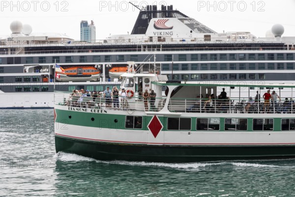 Detroit, Michigan - The sightseeing ship Diamond Queen passes the Viking Octantis luxury cruise