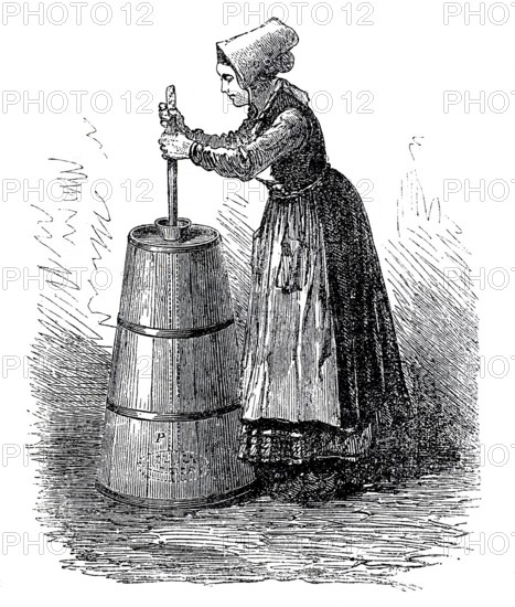 Dairy farming, woman making butter with a butter churn, around 1860, digitally enhanced