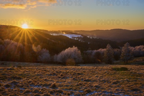 Sunset over snowy hills with a warm orange light, winter, Route de Cretes, Hohneck, La Bresse,
