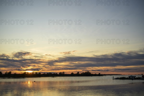 Idyllic view of the Gulf of Bothnia in the Kvarken Archipelago at sunset with calm water and