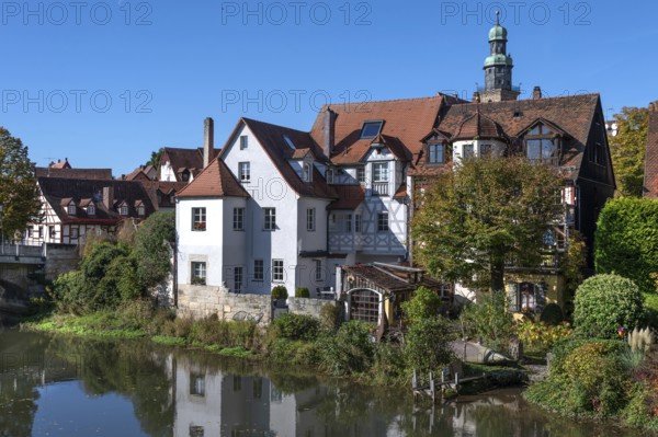 Old town houses located on the Pegnitz, behind the tower of St. John's Church, Lauf an der Pegnitz,