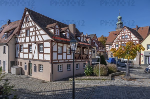 Historic half-timbered houses in the old town, tower of St. John's Church in the back, Lauf an der