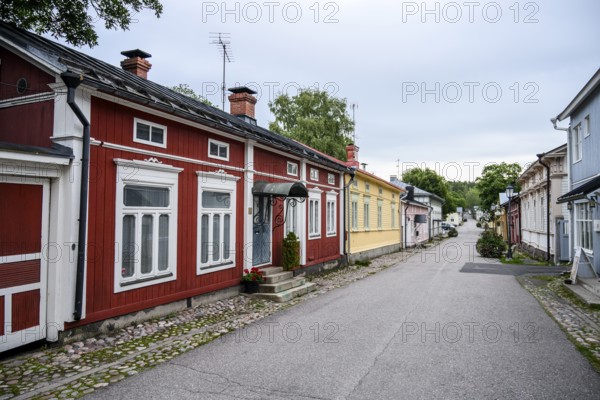 Street scene in the old town of Naantali, colorful traditional buildings on a paved, quiet street,