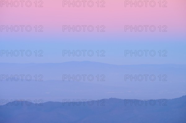 Rolling hills under a pink and blue sky at sunset, looking towards the Rhine Valley, Hohneck, La