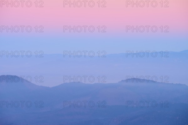 Foggy mountains spreading out under a pink sky, sunset, looking towards the Rhine Valley, Hohneck,