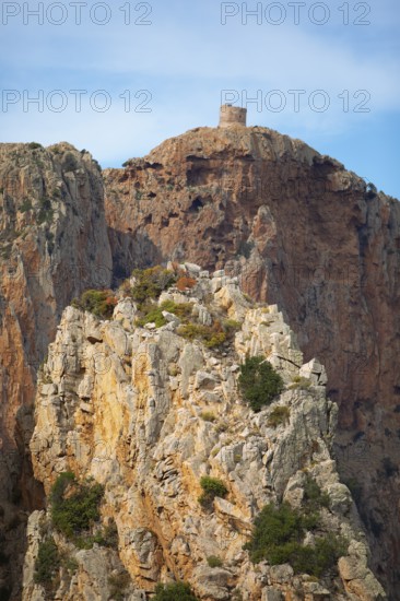 Bizarre rock formations on Capo Rosso, a Genoese tower blurred in the back, Piana, Corse-du-Sud