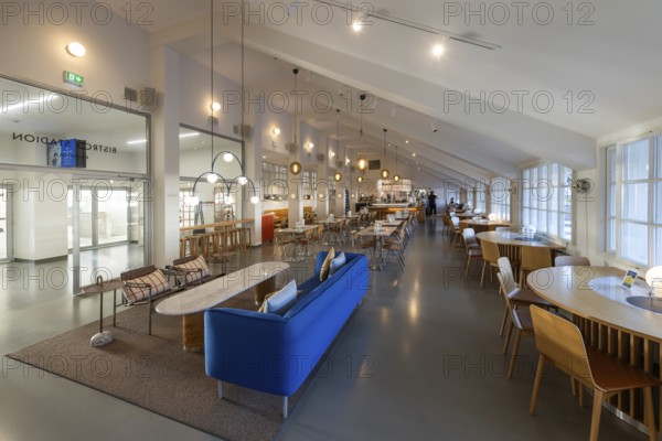 A 1950s style restaurant with seating, tables, large windows and hanging lamps, Olympic Stadium,