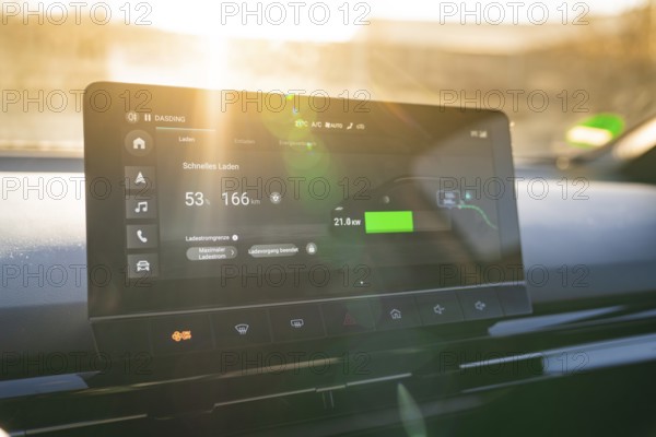 Modern car display provides information about fast charging, embedded in stylish interior, MG4