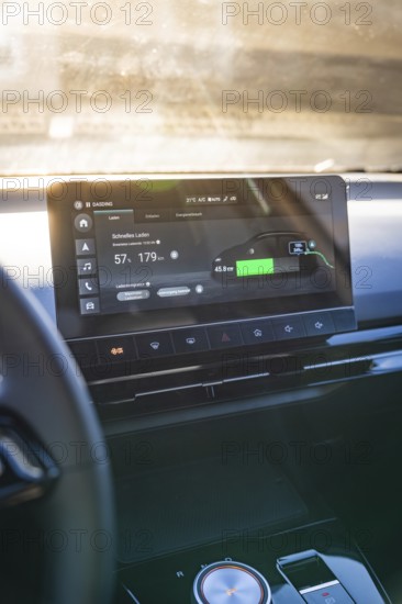 Modern car display with charging information and user interface in sunlight, MG4 electric car, Deer