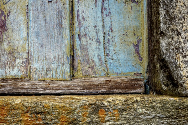 Colors and textures of an old wooden window weathered by time, in the city of Ouro Preto, Ouro