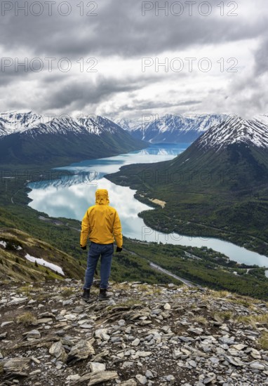 Climber enjoying the view, Slaughter Ridge Trail, view of snowy mountains and turquoise blue Kenai