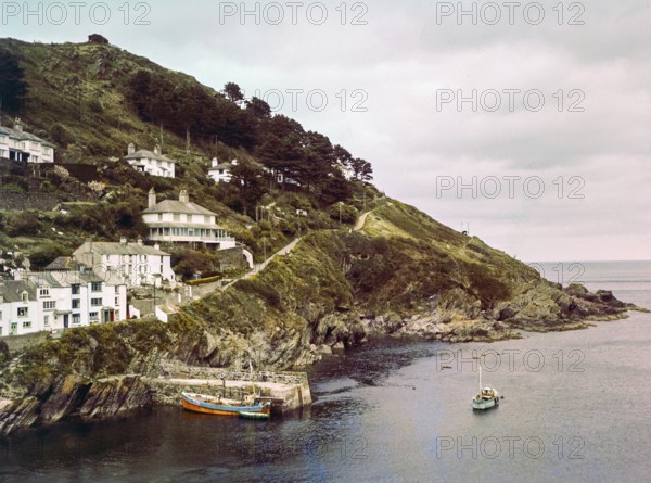 Historic waterfront buildings around the harbour river mouth of the River Pol at village of