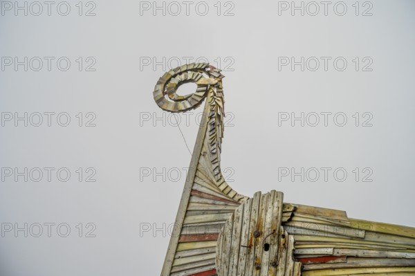 Close-up of an artfully designed wooden Viking dragon head, sculpture by Drakkar Vardø. The