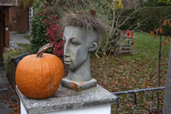 Head of a figure and a pumpkin on a garden wall, Franconia, BNayern, Germany