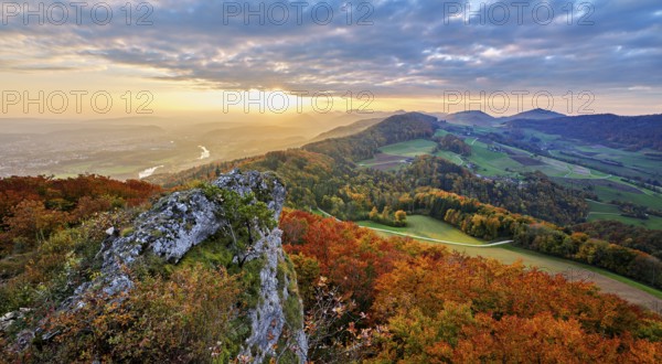 View from the Gisliflue of an autumn-colored forest, behind the Jurassic foothills with water fluh