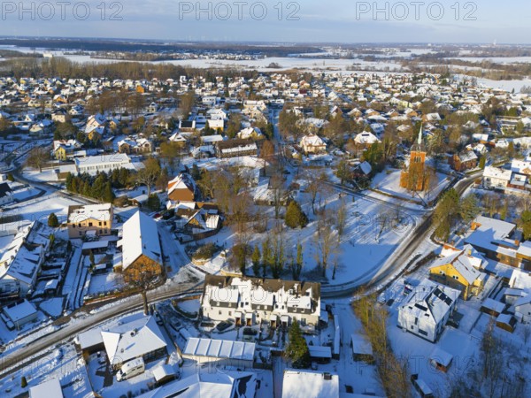 Snowy town view with many houses, a church and snow-covered roads, aerial view, Trinity church,