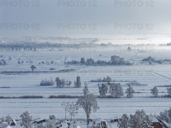 The onset of winter with snow and ground fog in Hamburg's Kirchwerder Wiesen Nature Reserve in the