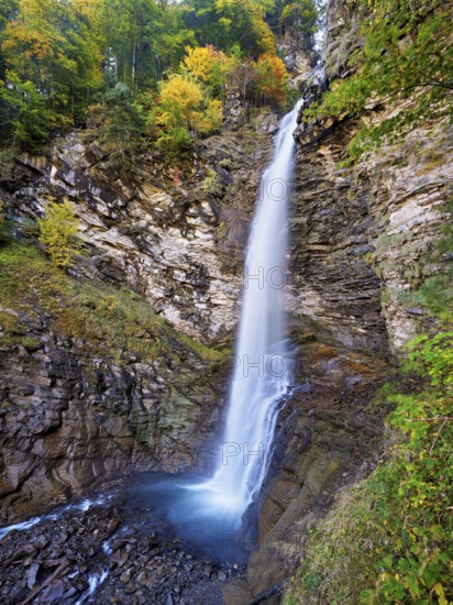 Diesbach waterfall in autumn-colored surroundings, Linthal, Klausenpass, Canton of Glarus,