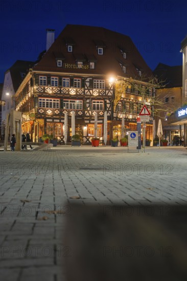 Traditional half-timbered hotel at night with lighting on an urban square, Nagold, Calw district,