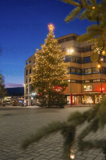 Christmas tree with lights in front of a building in an urban area at night, Nagold, Calw district,