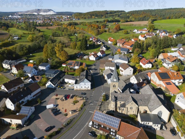Wide view of a village with church, nestled in an autumn landscape, aerial view, Niederkalbach,