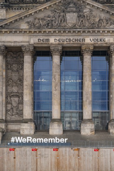 Construction fences and letters with the hashtag We Remember in memory of the victims of fascism