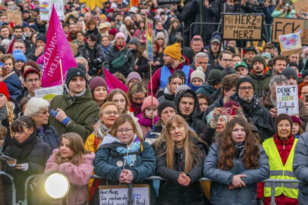 Participants with flags and posters at the demonstration against the right and for the preservation