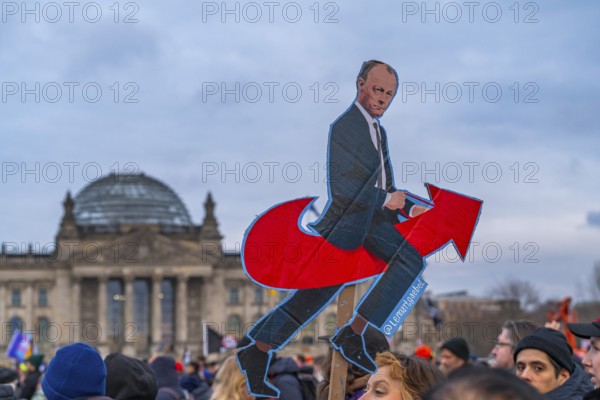 Photo of Federal Chancellor Friedrich Merz on the AfD arrow logo, demonstration against the right